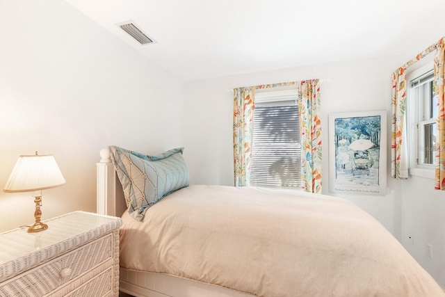 bedroom featuring multiple windows and visible vents