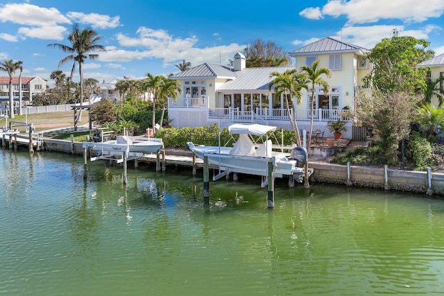 dock area with a water view and boat lift