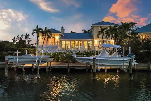 dock area with a water view and boat lift