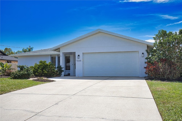 ranch-style house featuring a garage, driveway, and stucco siding