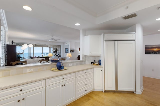 kitchen with recessed lighting, visible vents, backsplash, light wood-style floors, and white cabinets