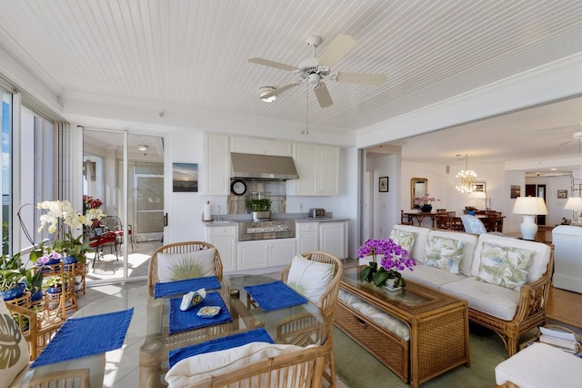 living room featuring ceiling fan with notable chandelier and light tile patterned flooring