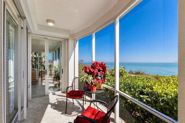 sunroom / solarium with a water view