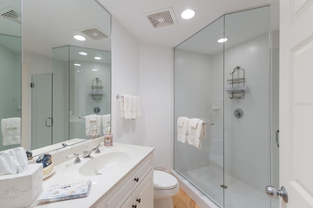 bathroom featuring a stall shower, visible vents, and toilet