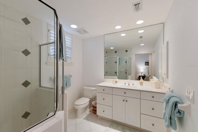 bathroom featuring toilet, a stall shower, visible vents, and vanity