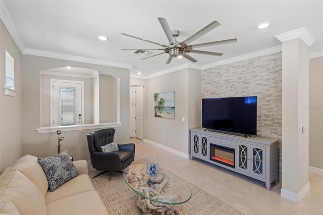 living area with baseboards, visible vents, and crown molding