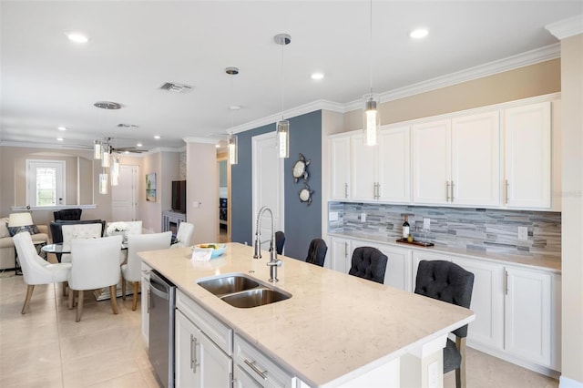 kitchen with a sink, visible vents, white cabinetry, open floor plan, and stainless steel dishwasher