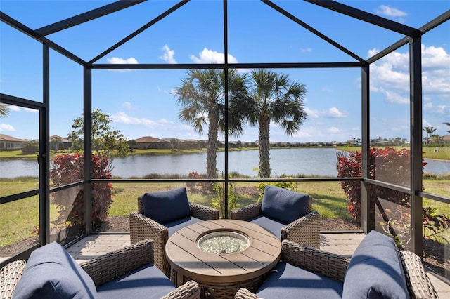 sunroom featuring a water view