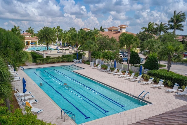 pool featuring a patio area and fence