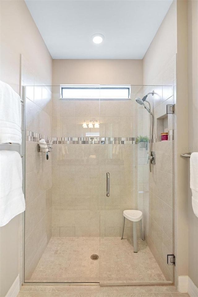 13137 Oriago St, Venice, FL 34293 - bathroom with tile patterned floors, a stall shower, and baseboards