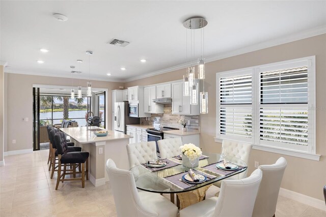 13137 Oriago St, Venice, FL 34293 - dining room with crown molding, visible vents, baseboards, and light tile patterned floors