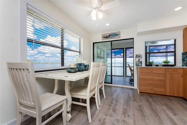 dining room with wood finished floors, a ceiling fan, and recessed lighting