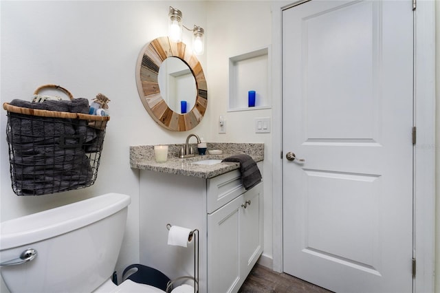 bathroom with toilet and vanity