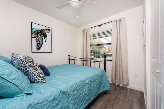 bedroom with ceiling fan, dark wood-type flooring, and baseboards