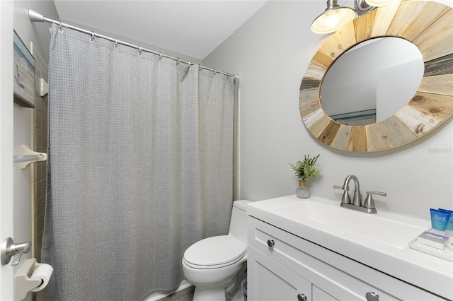 bathroom with toilet, curtained shower, and vanity