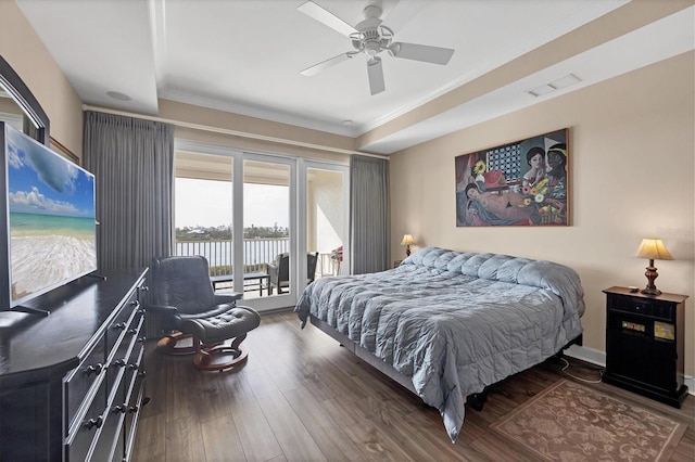 bedroom with visible vents, a ceiling fan, wood finished floors, a water view, and access to outside