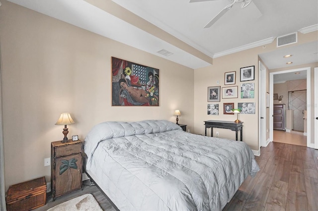 bedroom featuring baseboards, crown molding, visible vents, and dark wood-type flooring