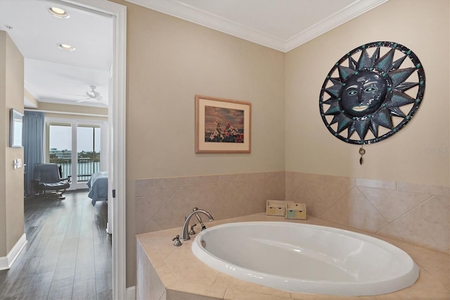 full bath with a garden tub, ceiling fan, ornamental molding, and wood finished floors