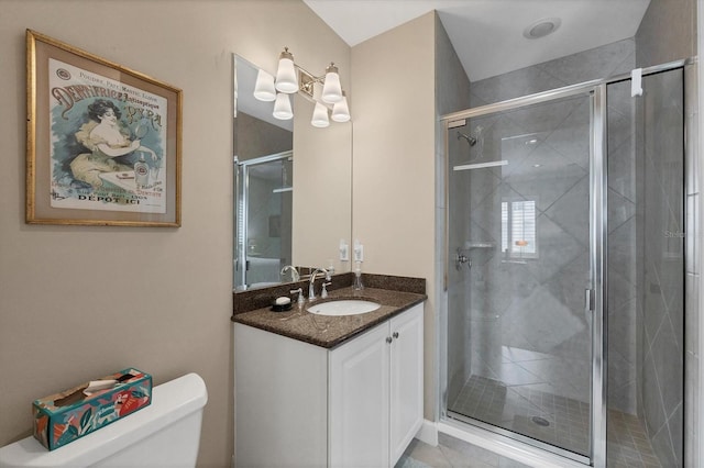 bathroom with a stall shower, vanity, and toilet