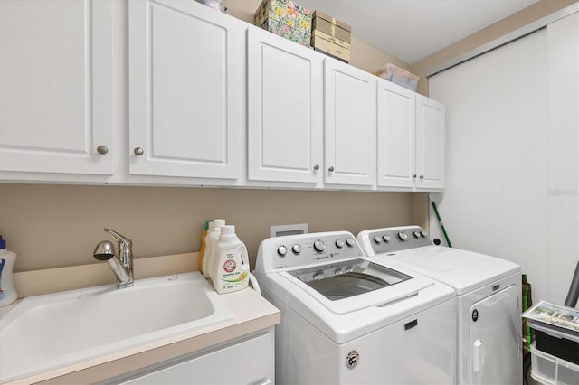 laundry room featuring a sink, cabinet space, and washer and dryer