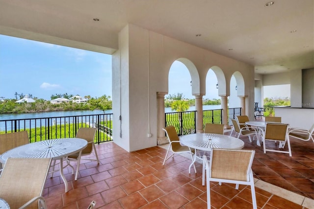 view of patio featuring outdoor dining space and a water view