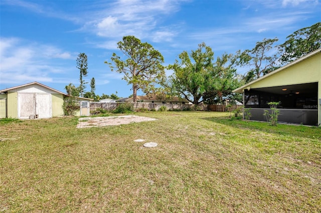 view of yard featuring fence and an outdoor structure