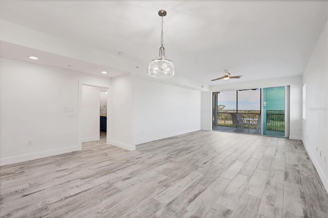 spare room featuring ceiling fan, recessed lighting, light wood-style flooring, and baseboards