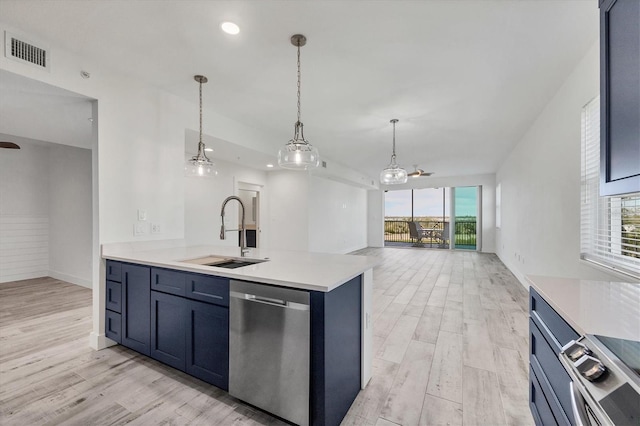 kitchen with stainless steel appliances, a sink, visible vents, light wood-style floors, and light countertops