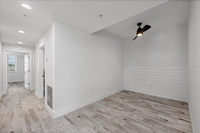 empty room with baseboards, visible vents, wood finished floors, and recessed lighting