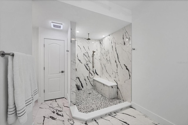 full bath with marble finish floor, stone wall, a marble finish shower, and baseboards