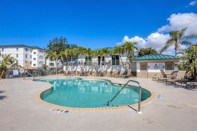 pool featuring a patio area and fence