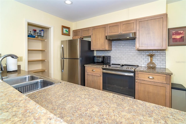 kitchen featuring brown cabinets, backsplash, appliances with stainless steel finishes, a sink, and under cabinet range hood