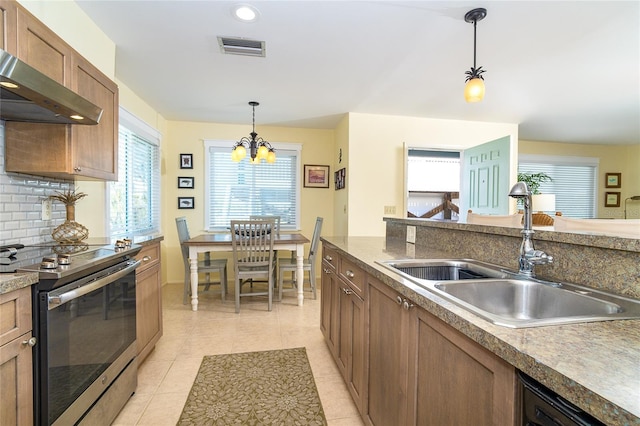 kitchen featuring visible vents, decorative backsplash, stainless steel range with electric cooktop, a sink, and exhaust hood