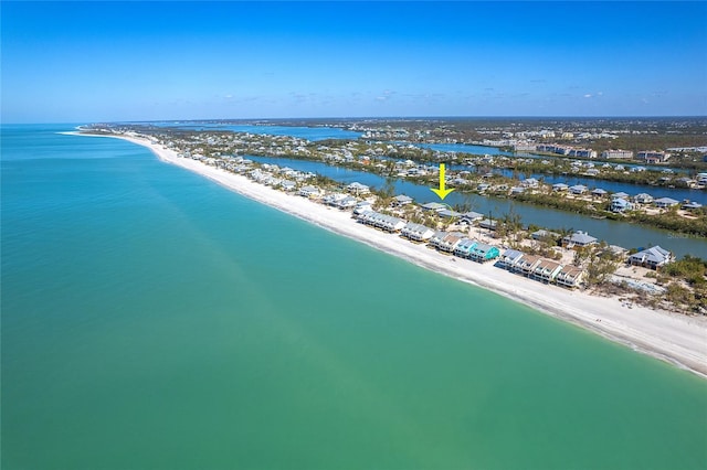 aerial view featuring a water view and a beach view