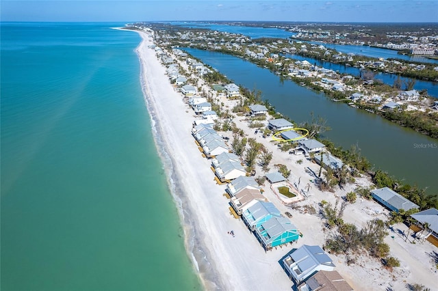 drone / aerial view with a water view and a view of the beach