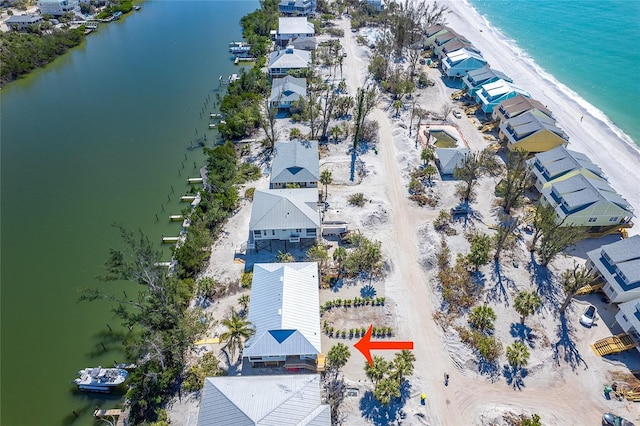 drone / aerial view featuring a beach view and a water view