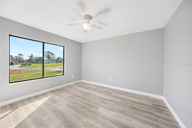 empty room with light wood-style floors, baseboards, and a ceiling fan