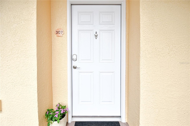 property entrance featuring stucco siding