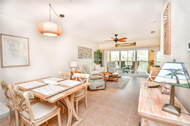 dining room with light tile patterned flooring, visible vents, and a ceiling fan