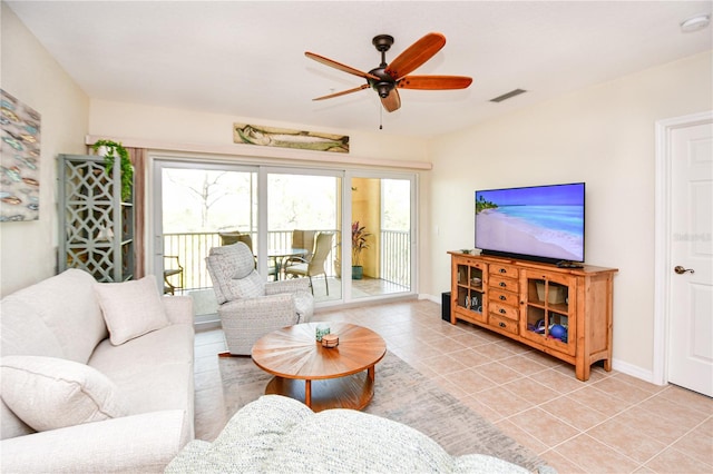 living room featuring light tile patterned floors, plenty of natural light, visible vents, and a ceiling fan