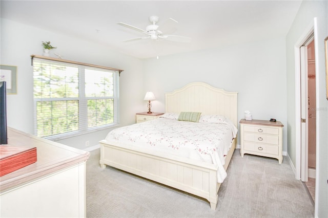 bedroom featuring baseboards, ceiling fan, and light colored carpet