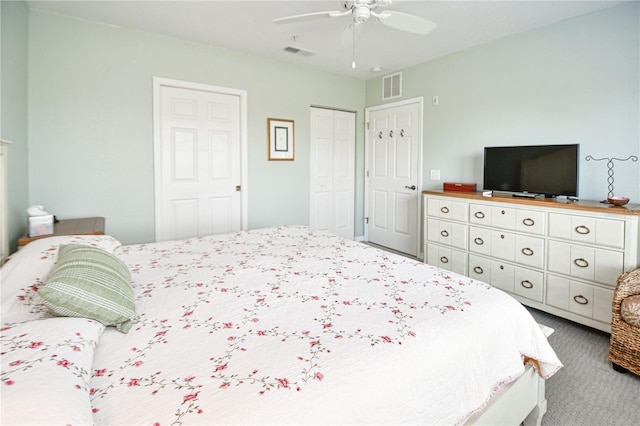 carpeted bedroom featuring ceiling fan, visible vents, and a closet