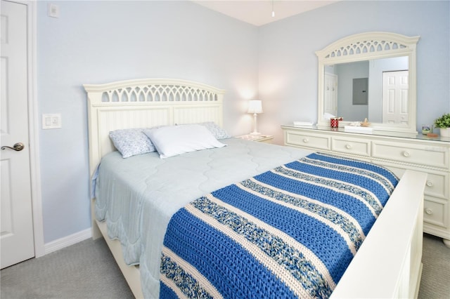 carpeted bedroom featuring electric panel and baseboards