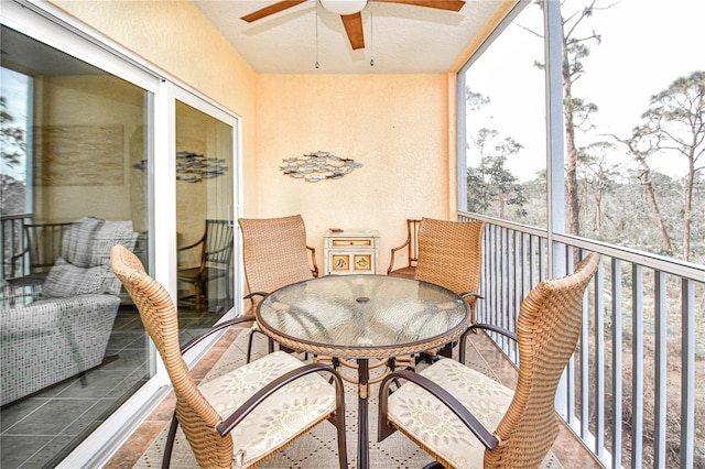 balcony featuring outdoor dining space and a ceiling fan