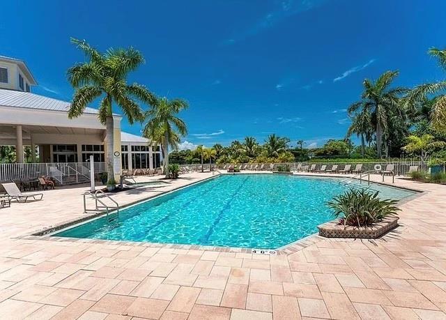 community pool featuring fence and a patio