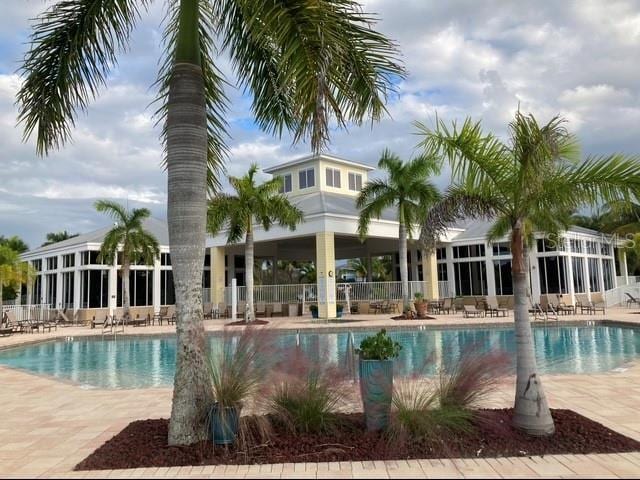 community pool featuring a patio area and fence