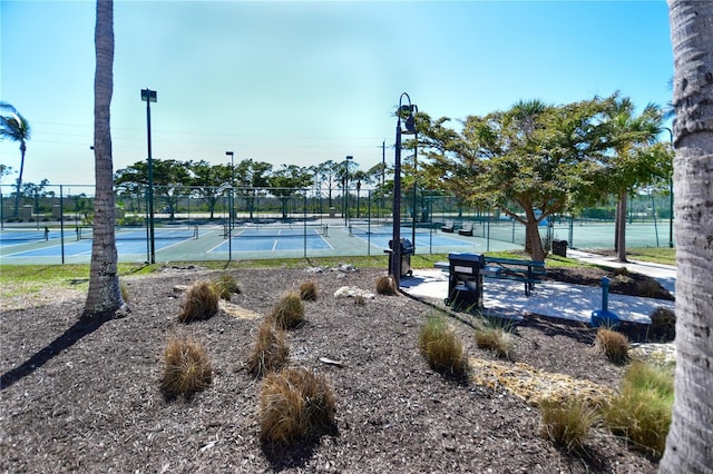 view of tennis court featuring fence