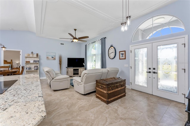 living room featuring visible vents, lofted ceiling, french doors, baseboards, and ceiling fan