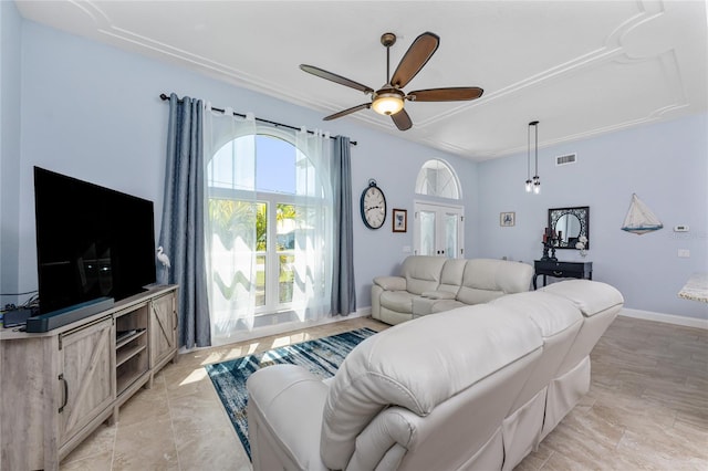 living room with visible vents, baseboards, and ceiling fan