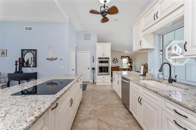 kitchen with visible vents, a sink, stainless steel appliances, ceiling fan, and white cabinets